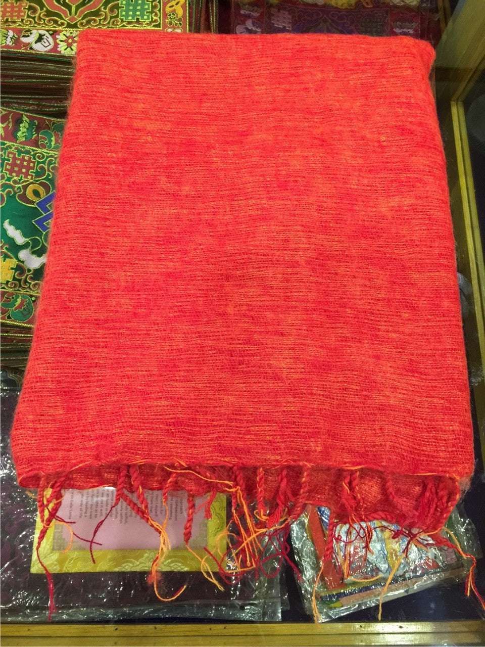 A stunning orange medium yak wool zen or meditation shawl.These shawls are intended to surround the person during the meditation session and are believed to hold the energy that accumulates and also has a beneficial effect on the mind. As the body cools down during meditation, extra warmth is provided by the shawl helping the body and stopping the mind from distraction. This shawl is perfect for meditating, to lie on, as a cover up, or to wrap up in to keep warm.They are also popular for ordained Tibetan mo