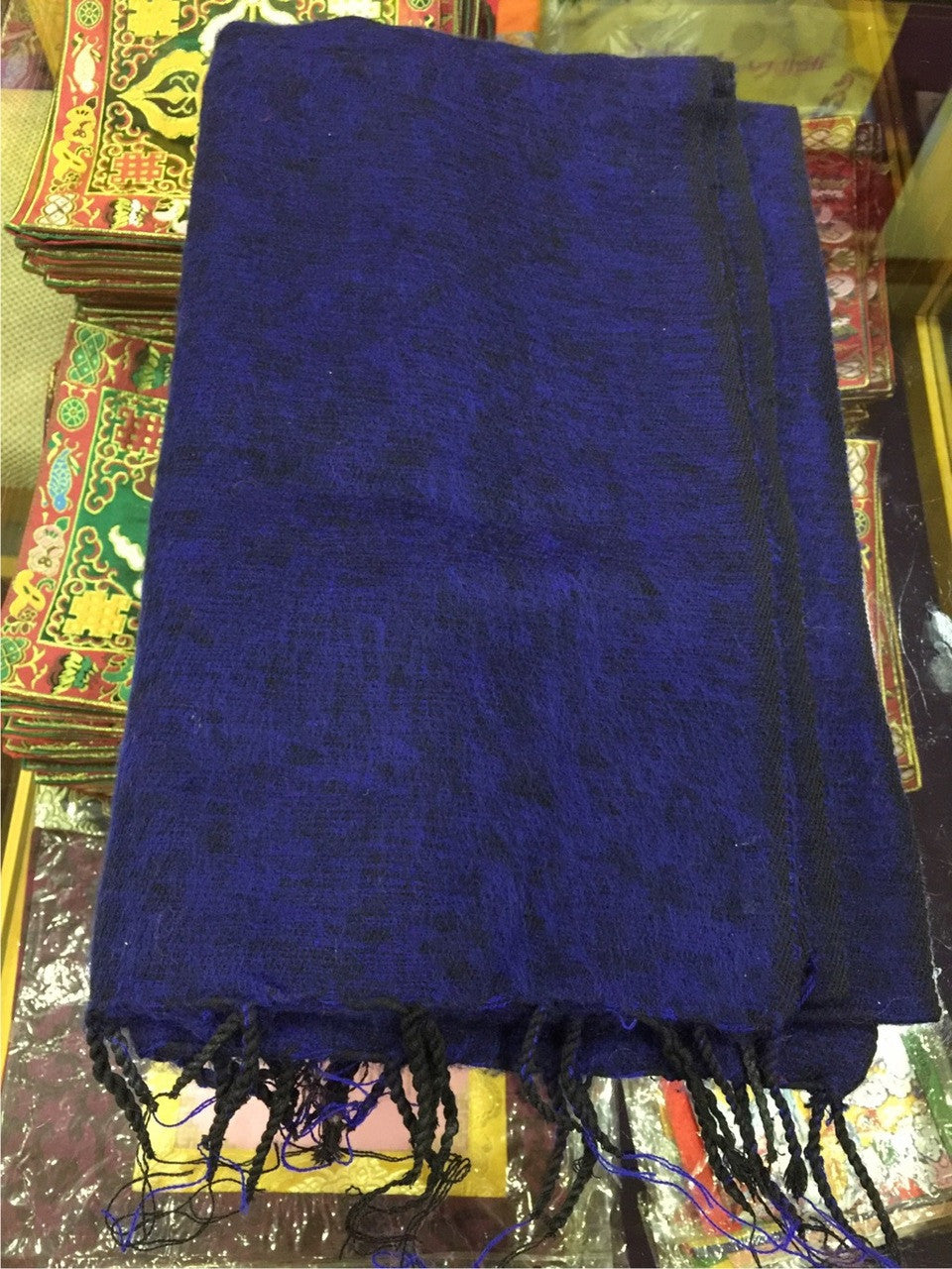 A stunning Blue medium yak wool zen or meditation shawl.These shawls are intended to surround the person during the meditation session and are believed to hold the energy that accumulates and also has a beneficial effect on the mind. As the body cools down during meditation, extra warmth is provided by the shawl helping the body and stopping the mind from distraction. This shawl is perfect for meditating, to lie on, as a cover up, or to wrap up in to keep warm.They are also popular for ordained Tibetan monk